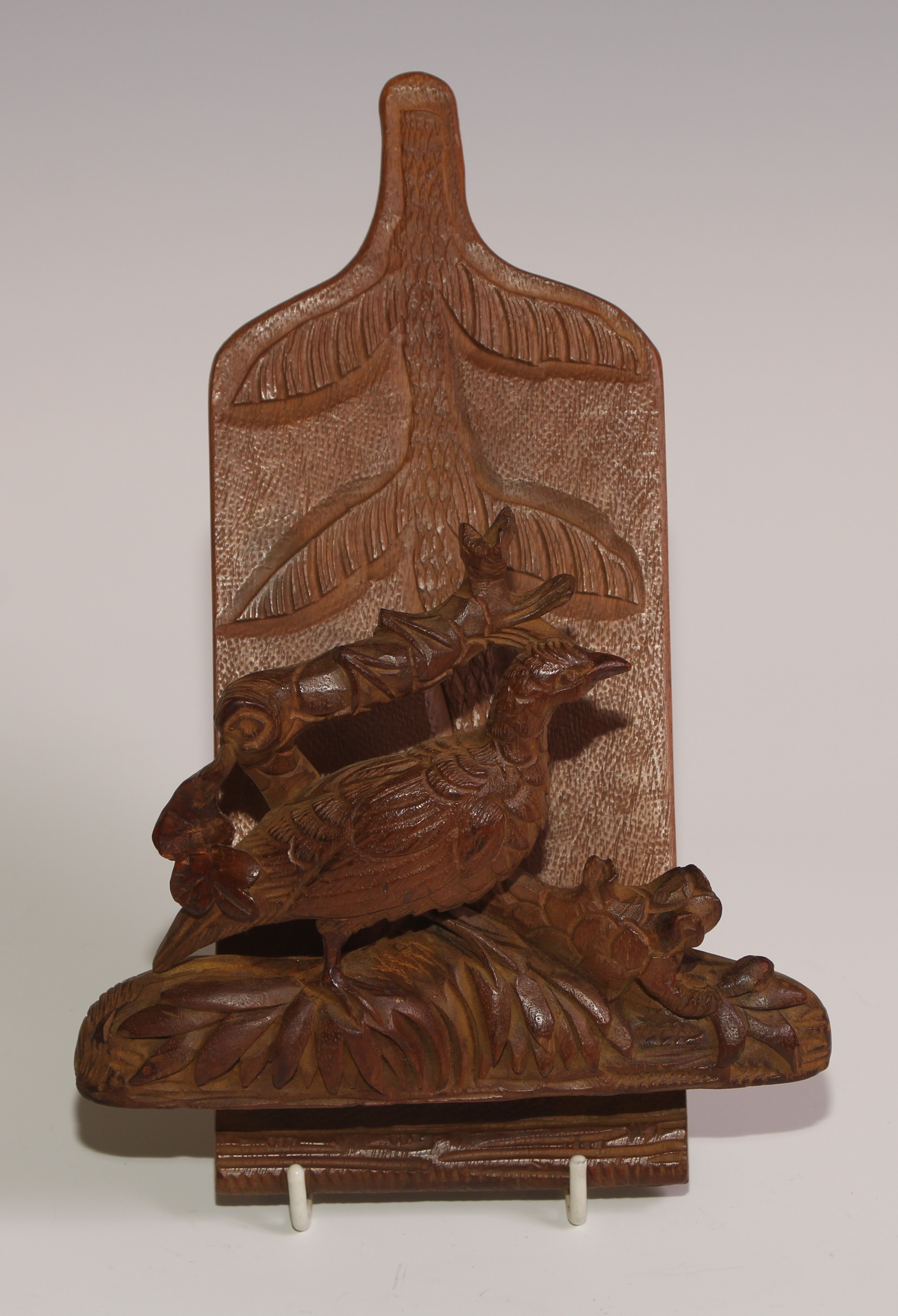 A Black Forest novelty wall hanging letter rack, carved with a game bird, 21.5cm long, c.1900 (re-