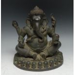 Indian School, a verdigris patinated bronze, Ganesh on a Throne of Skulls, 24cm high, probably