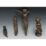 A bronze Corpus Christi, 24cm high; a bronze finial, of a seated putto,. 10.5cm high; a bronze of