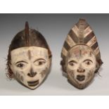 Decorative Tribal Art and the Eclectic Interior - a Baule mask, lofty stylised coiffure, scarified