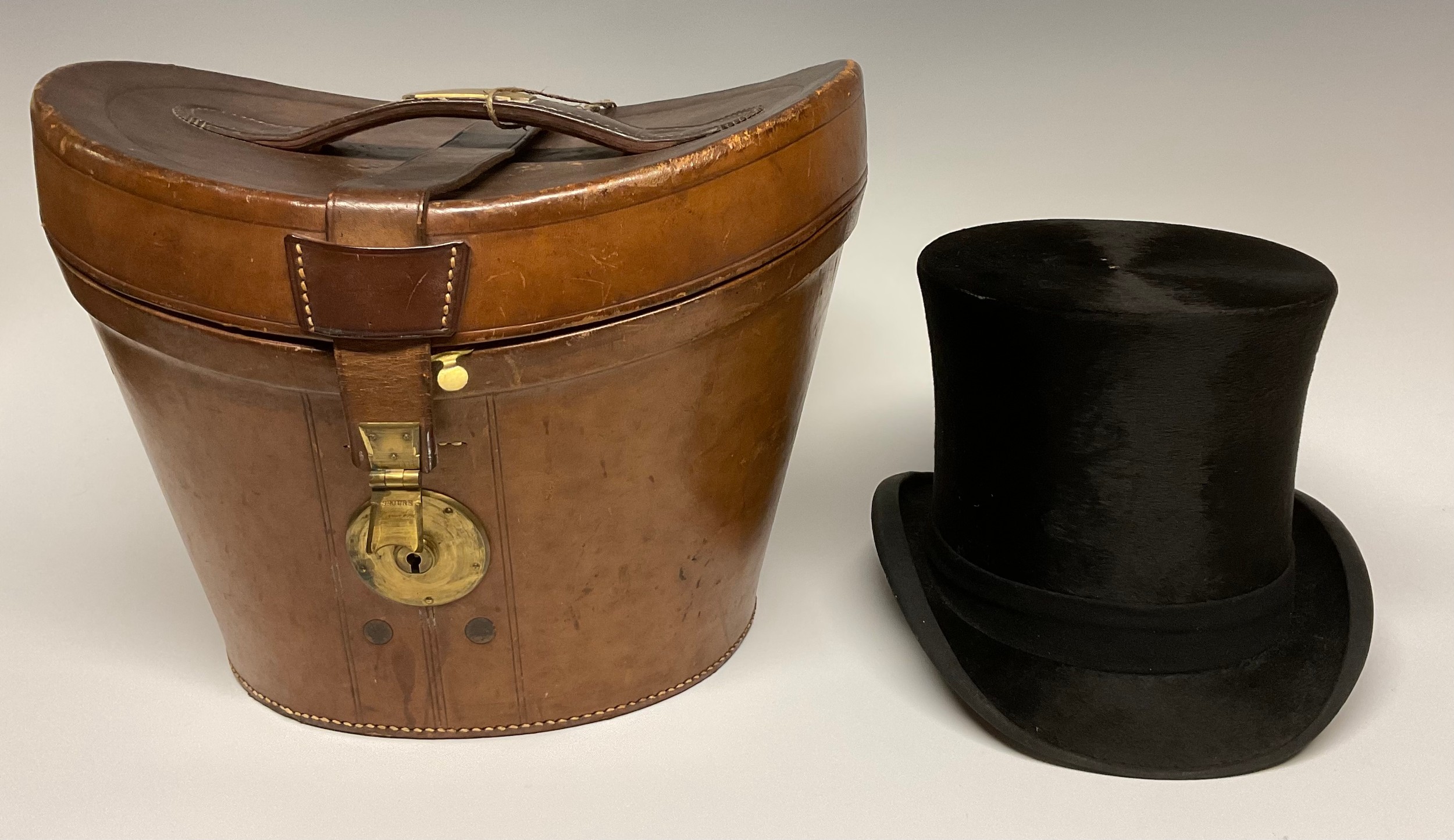 A 19th century leather top hat box, brass fittings, 35cm wide, c.1880; enclosing a silk top hat,