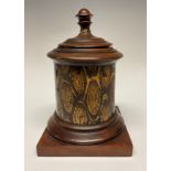 A 19th century exotic timber and mahogany tobacco jar, turned cover and socle, square base, zinc