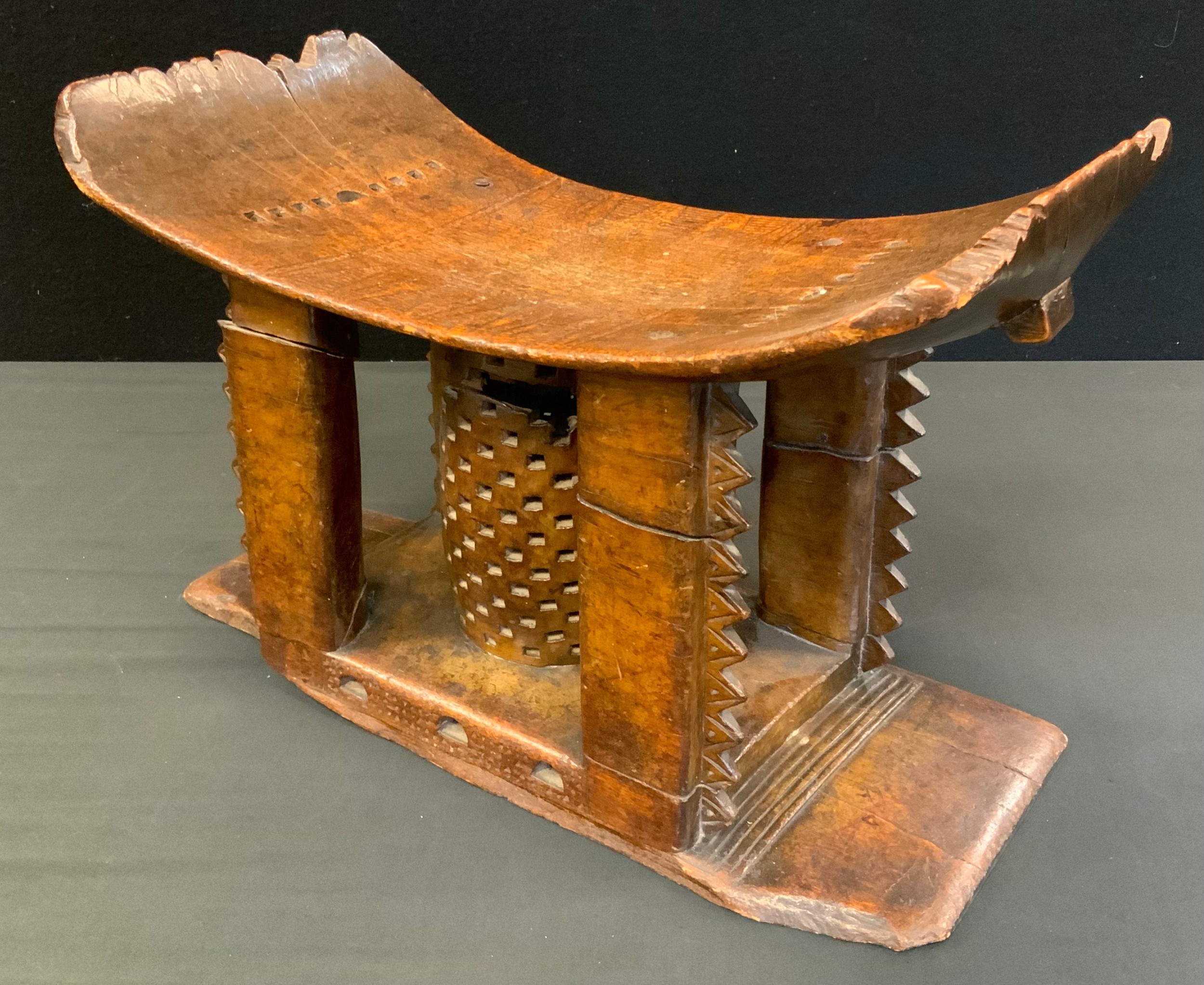 Tribal Art - a 19th century Ashanti stool or seat, arched rectangular seat with four carved supports - Image 3 of 4