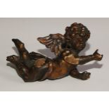 A 19th century Italian carved limewood putto, 28cm wide