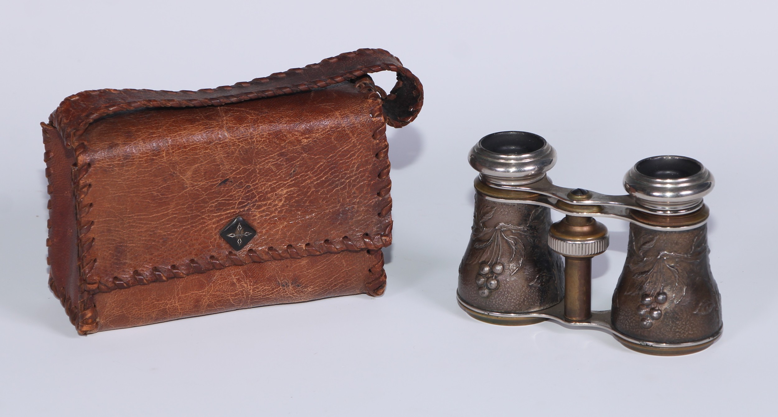 A pair of French Aesthetic Movement opera glasses, decorated in relief with birds on fruiting