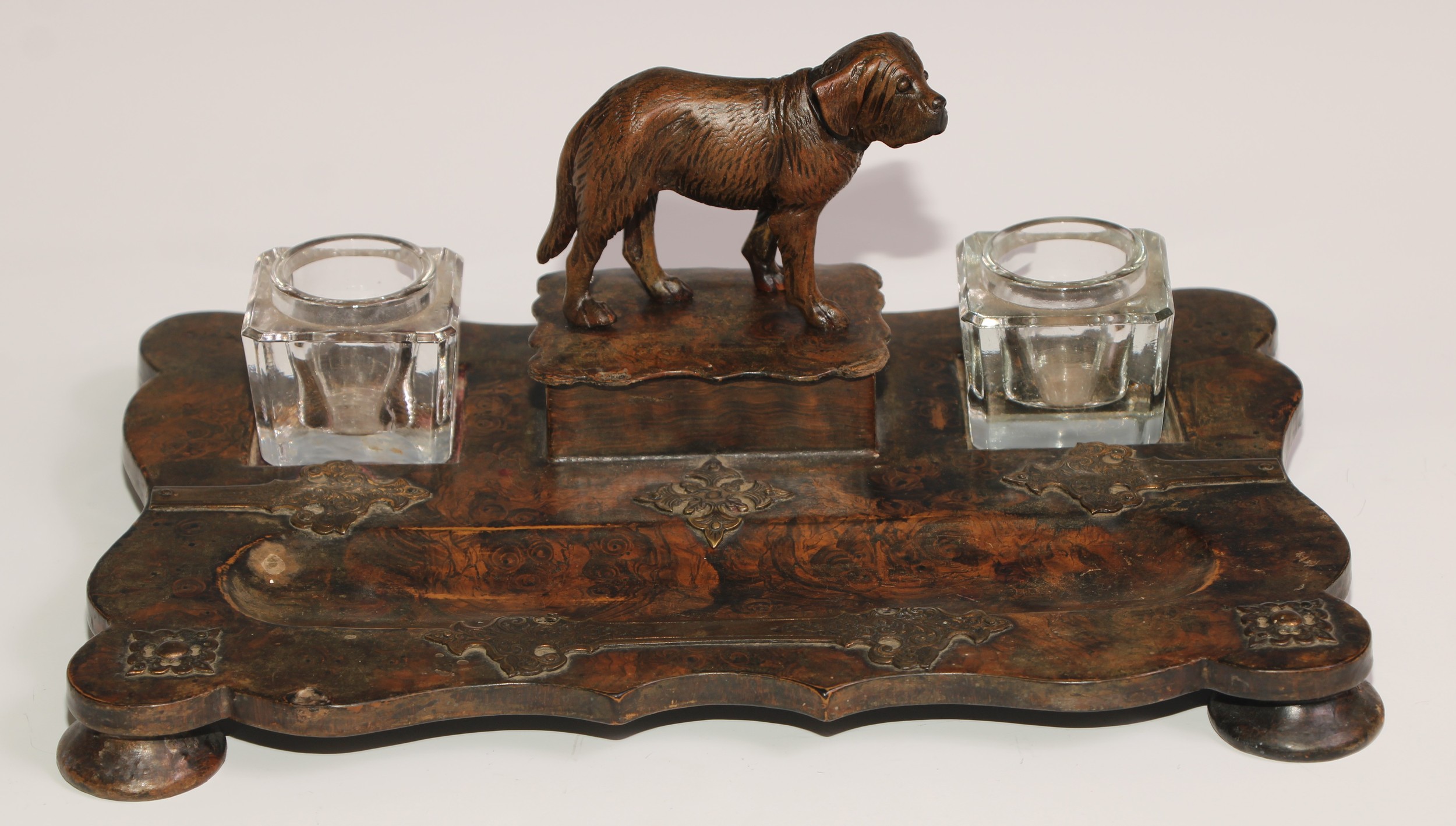 A Victorian papier mache inkstand, scumbled in faux burr walnut and applied with brass cut-card