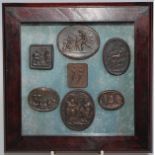An arrangement of bronze-finished plaster intaglio impressions, various Grand Tour subjects, 18cm
