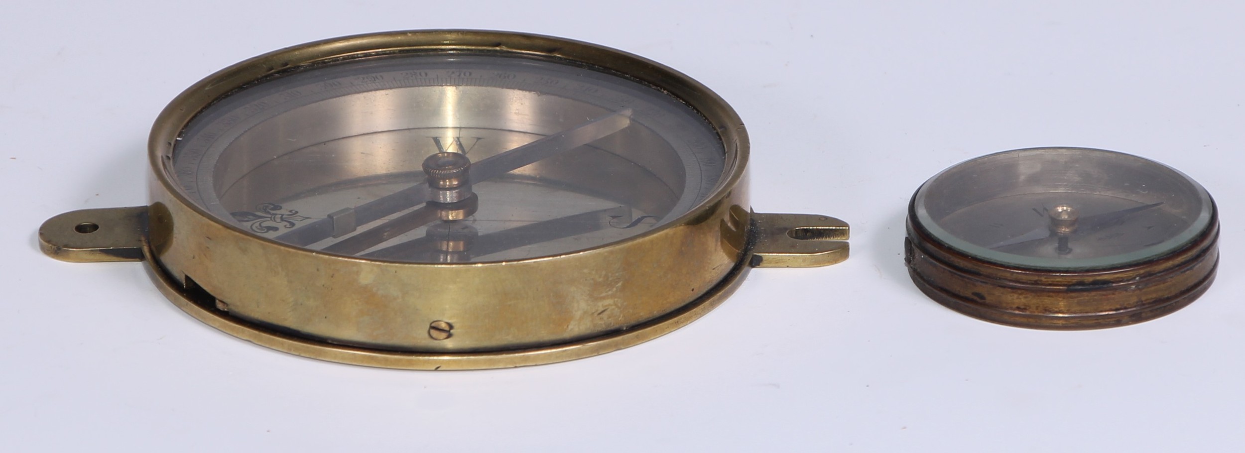A 19th century brass compass, 8.5cm silvered dial engraved with fleur-de-lys, lockable needle,