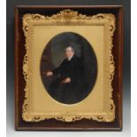 A 19th century portrait, of a gentleman in his library, oval, oil on photograph, oval, 24cm x