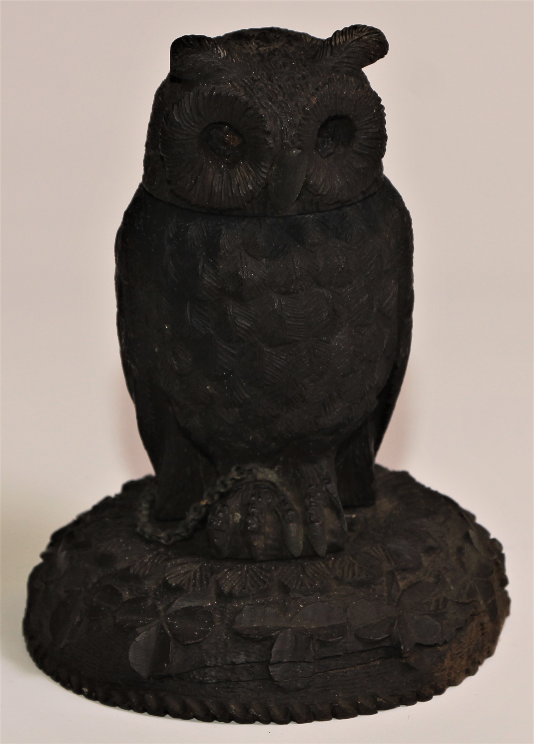 An Irish bog oak ink well carved as an owl, 12.5cm high, early 20th century