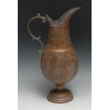 A Middle Eastern copper ewer, chased with scrolling foliage, tinned interior, 34cm high