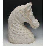 A large alabaster carving, the head of a horse, wearing a bridle and elaborate tack, 40cm high