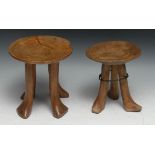 Tribal Art - an Ethiopian carved tripod stool, 18.5cm high; another similar, 20cm high (2)