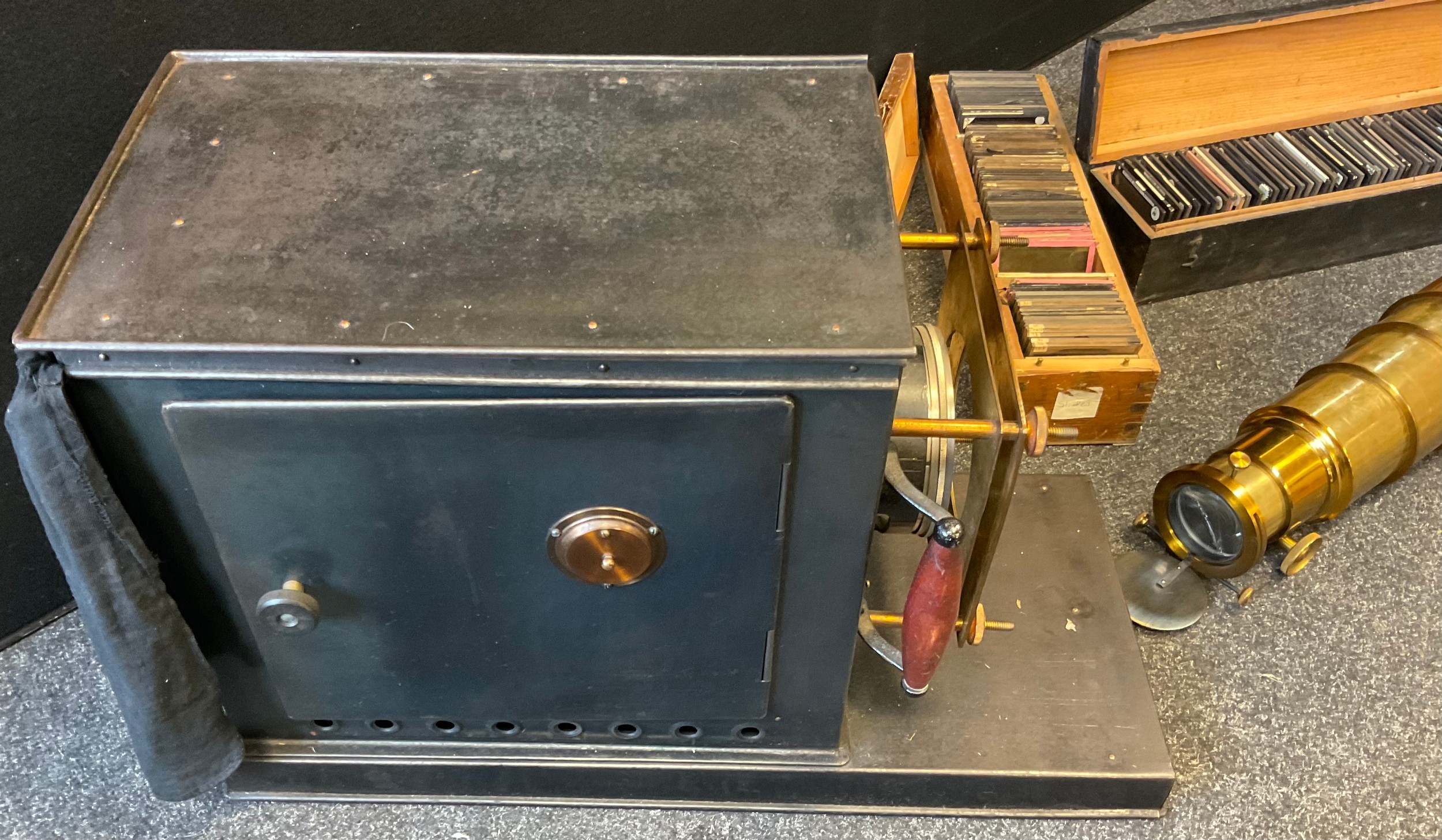 A late Victorian lacquered brass and black painted magic lantern, c.1890; two boxes of slides, - Image 2 of 3