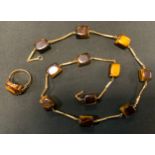 A tiger eye oval panel dress ring, indistinctly marked yellow metal shank; similar block bead