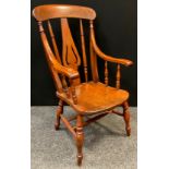 A 19th century fiddle-back elm armchair, double H-stretcher, turned legs, 110cm tall (42cm to