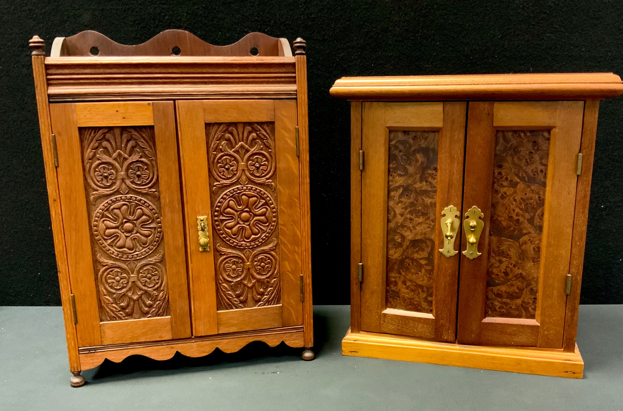 An Edwardian oak and pine smokers cabinet, two carved panel doors, fitted interior, 46cm high,