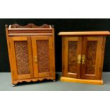 An Edwardian oak and pine smokers cabinet, two carved panel doors, fitted interior, 46cm high,