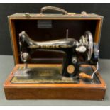 A Singer hand operated sewing machine, cased
