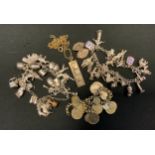 A silver charm bracelet, another suspending approx 50 charms; ingot pendant etc, 173g gross