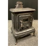 A cast iron solid fuel parlour stove / wood burner, external measurement- 70cm tall x 54cm wide x