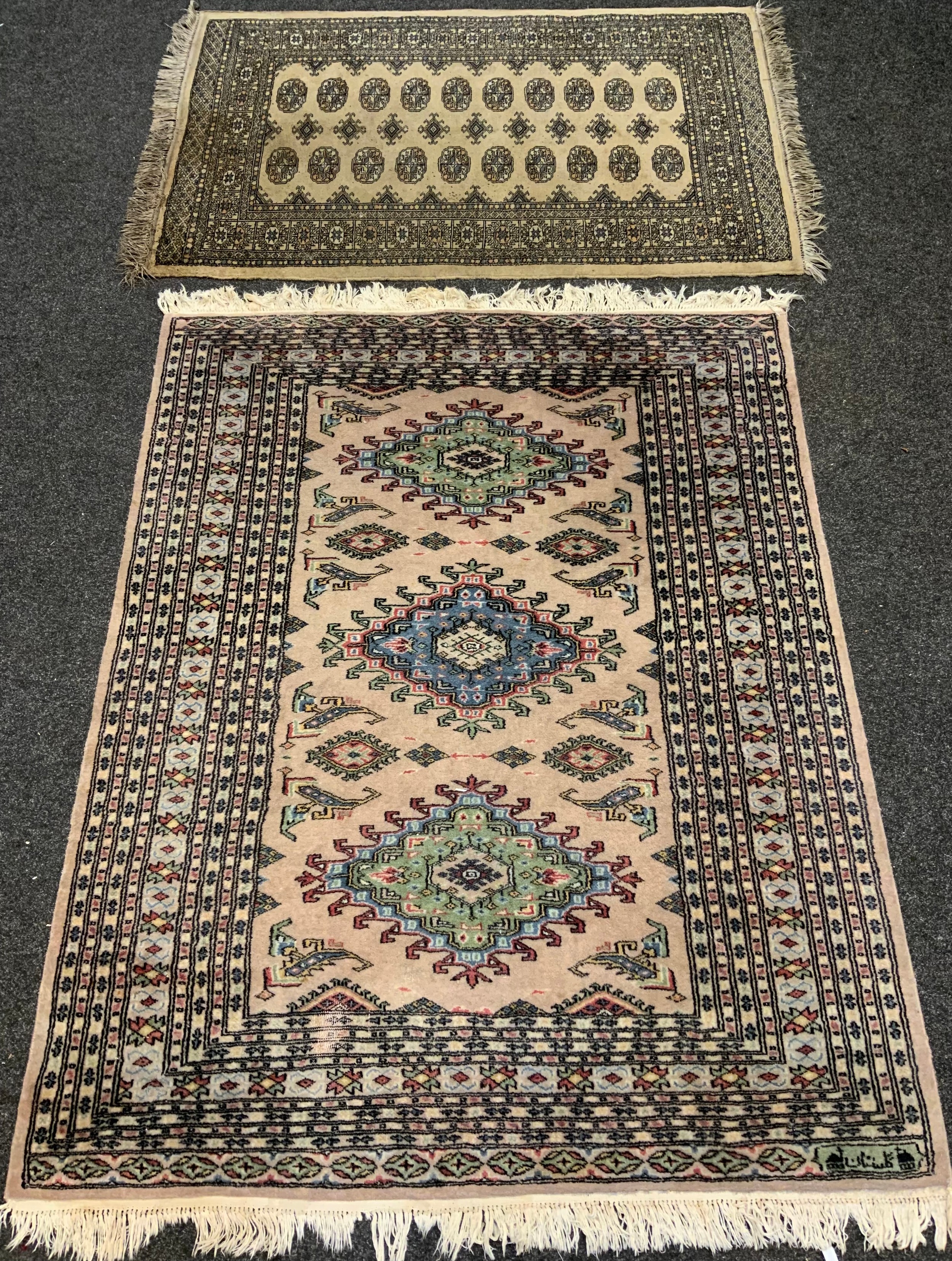 A middle eastern Bokhara, wool and silk mix rug / carpet, knotted with traditional ‘Gul’ motif,