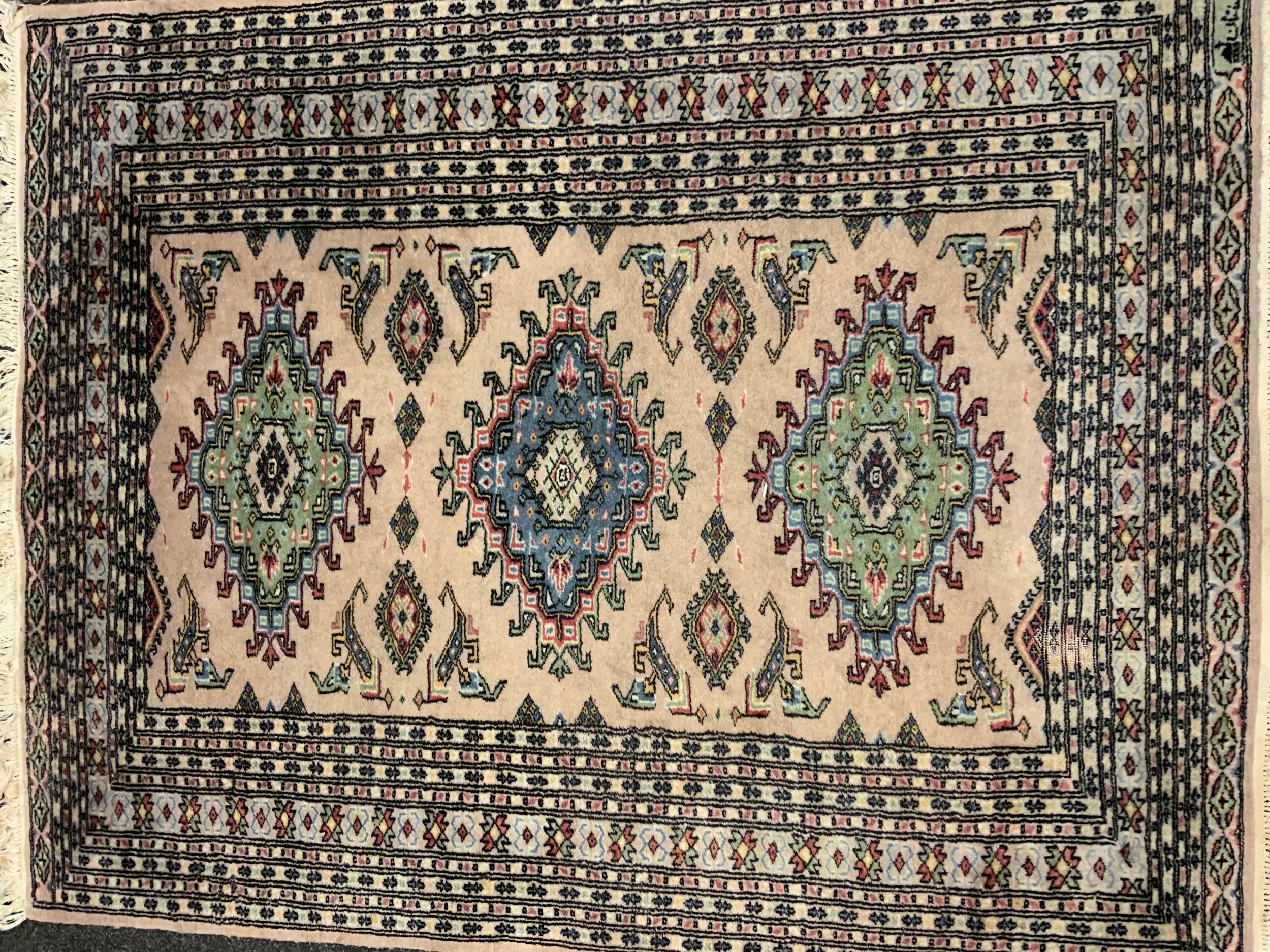 A middle eastern Bokhara, wool and silk mix rug / carpet, knotted with traditional ‘Gul’ motif, - Image 2 of 5