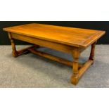 A Titchmarsh and Goodwin style oak coffee table, plank top, turned legs, H-stretcher, 46cm tall x