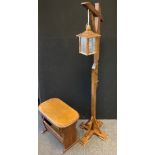 A mid 20th century oak magazine rack/side table, 57cm wide, 44cm high; an oak hangman lantern side