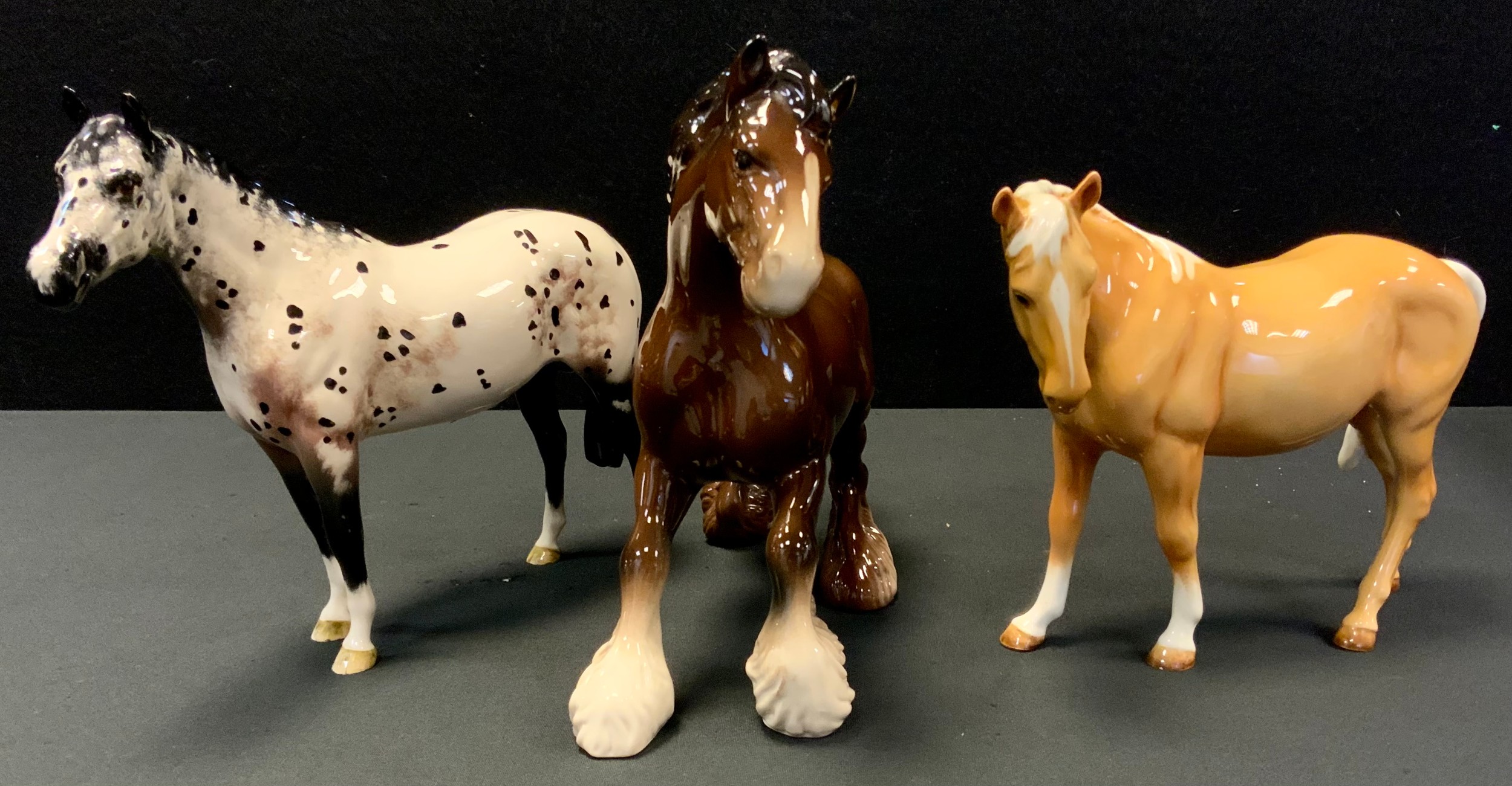 A Beswick model, Appaloosa horse; others Swish tail; Royal Doulton Cantering Shire (3)