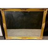 A large gilt framed wall mirror, bevelled glass, 91cm x 121.5cm.