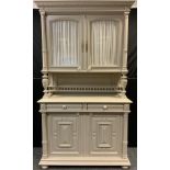 An early 20th century French painted narrow dresser, dentil cornice, pair of glazed doors to top,