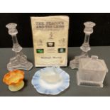 A pair of clear glass press moulded glass candlesticks, triform dolphin based, 20.5cm high; a