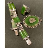 A modern Chinese Green stone possibly jade bracelet, pendant and ring suite, mottled tones, silver