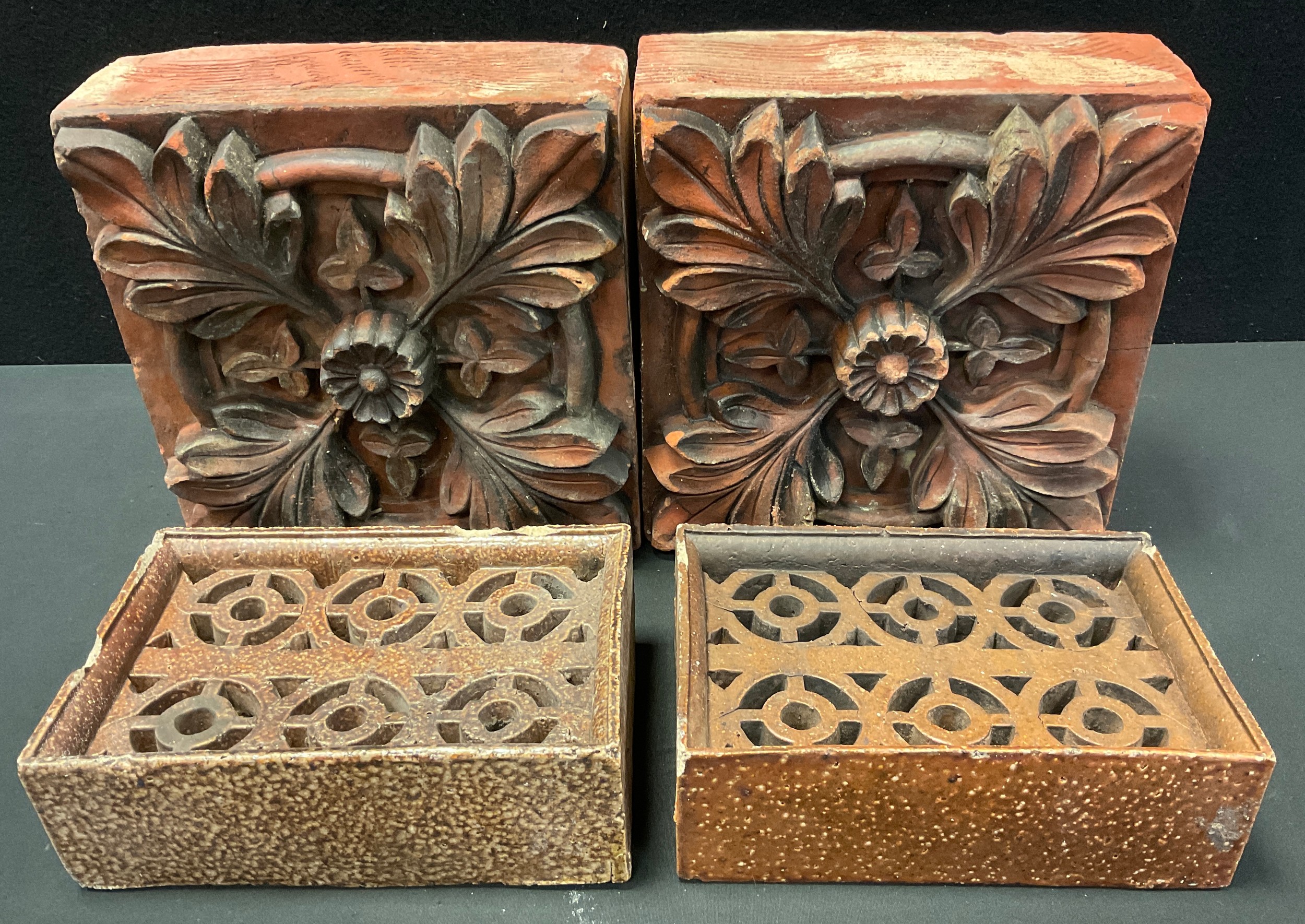 A pair of Victorian terracotta brick tiles, moulded with floral decoration, approx 26cm square;