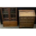 An early 20th century oak bureau bookcase (the top converted for use as a stand alone cabinet with