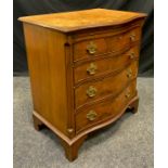 A George III style reproduction walnut serpentine-front bachelors chest, 20th century, 79.5cm tall x