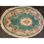 A Chinese oval deep pile woollen rug, green ground; others, circular, red ground , rectangular green