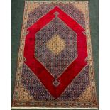 A Bijar rug / carpet, hand-knotted with a large central hexagonal shaped medallion in a rich red