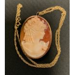 A 9ct gold mounted oval cameo pendant brooch, as a lady, with 9ct gold chain, 17.7g gross