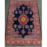 A Hamadan rug / carpet, hand-knotted in rich blue, red, white, and pale blue, 318cm x 212cm.