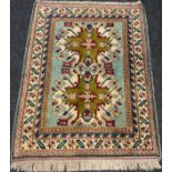 A Chelaberd or ‘Eagle Kazak’ style rug, knotted in subtle tones of blue, cream, earthy green, and