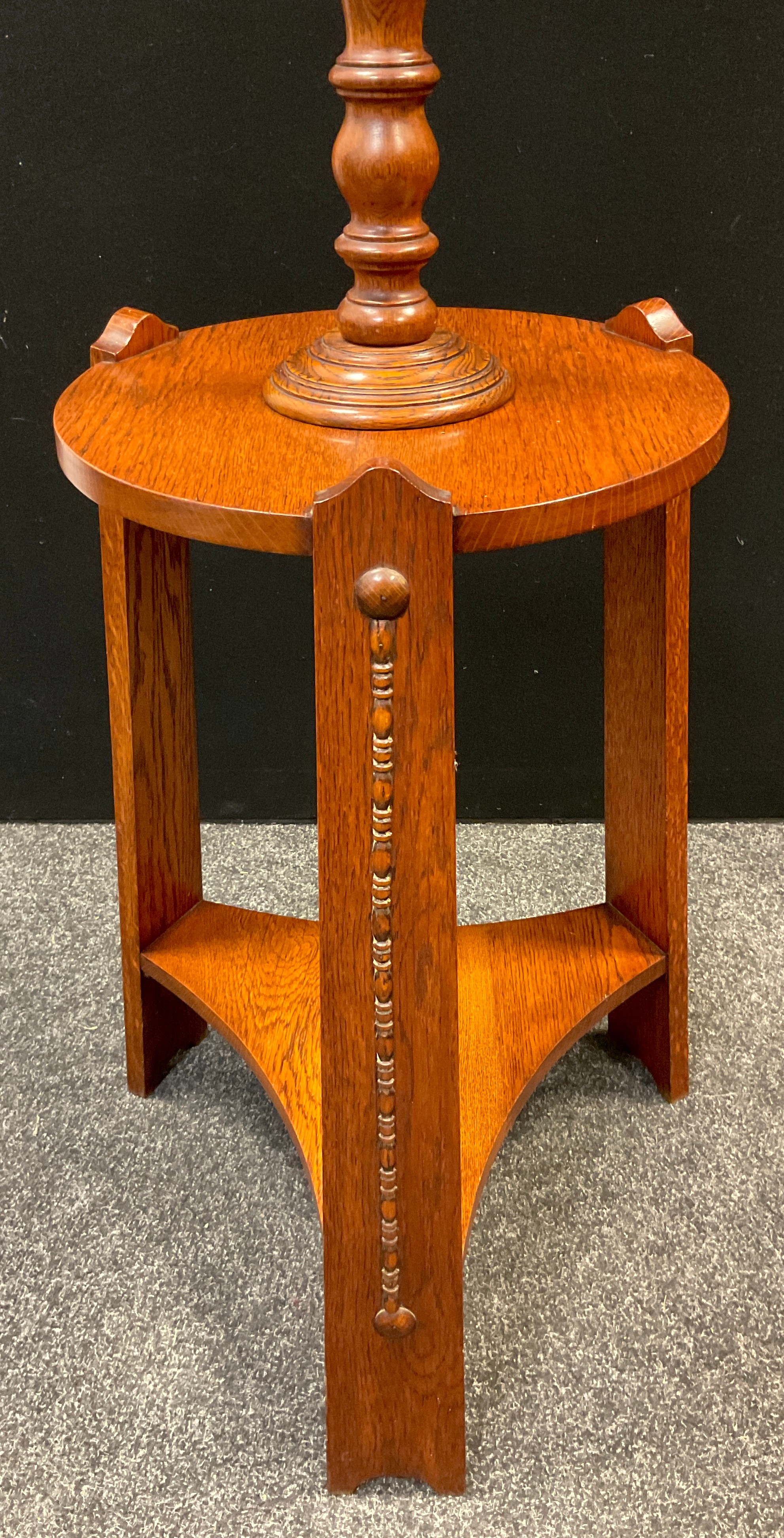 An Arts and Crafts oak table standard-lamp, turned lamp column to top, circular tripod table base, - Image 2 of 2