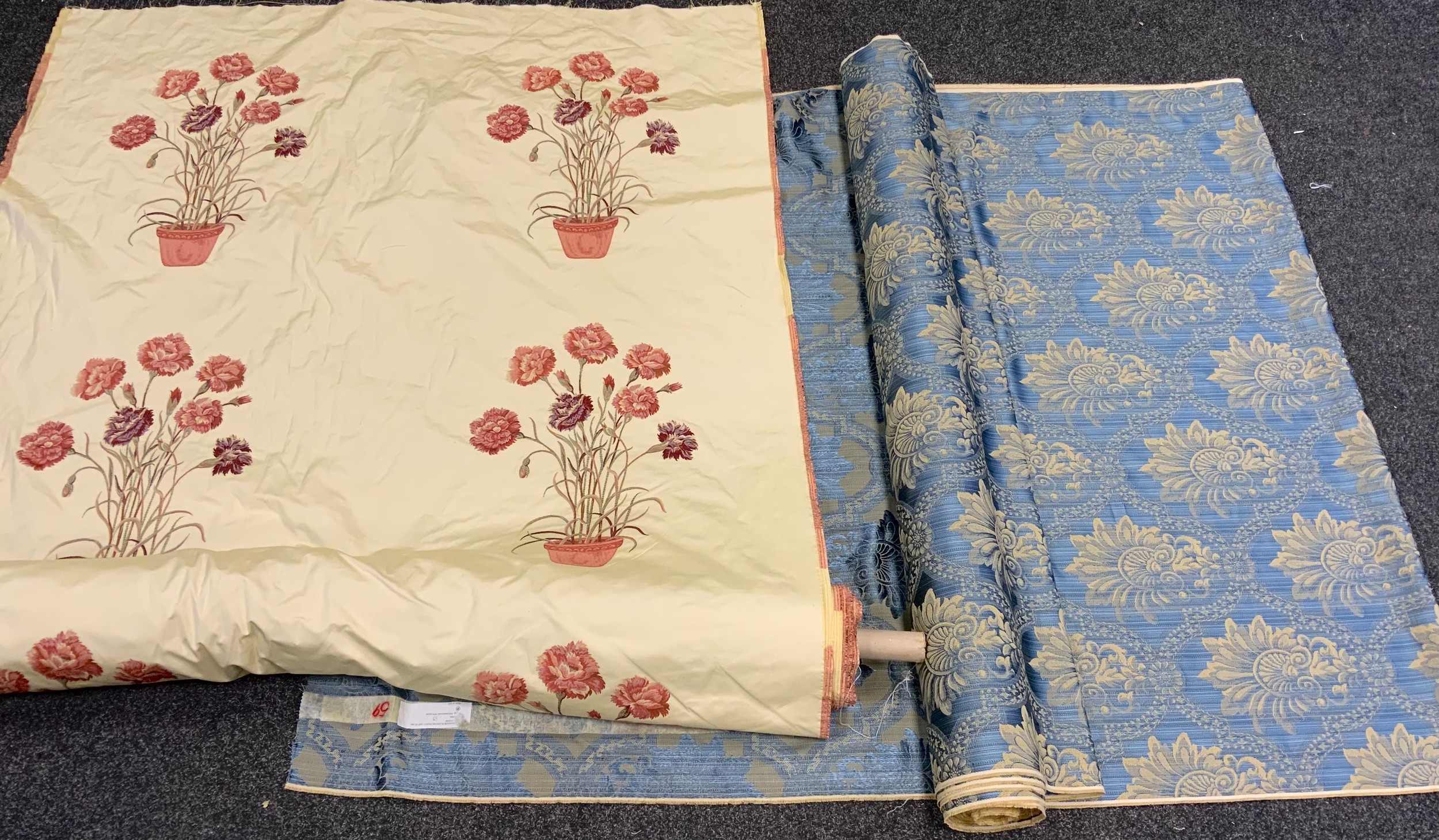 Textiles - a large roll of floral embroidered fabric, cream ground, approx 21 meters long; another