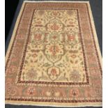 A Persian Heriz silk and wool rug / carpet, knotted in subtle tones of brown, cream, and coral, with