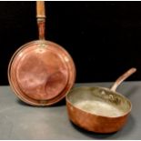 A 19th century copper and cast iron saucepan, 24.5cm dia; a warming pan (2)