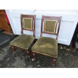 Pair of Oak chairs with upholstered seats and backs and brass castors to front legs