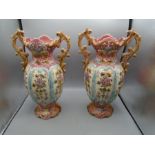 A pair of Rococo style vases in pink floral design 14" tall there is a slight crack on one and a