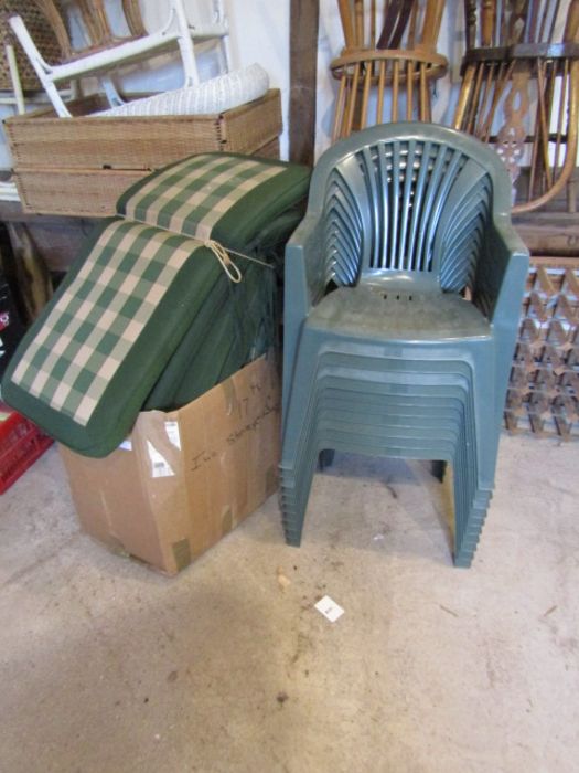 10 plastic garden chairs and box of seat pads