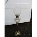 Oil lamp with white globe shade and brass base